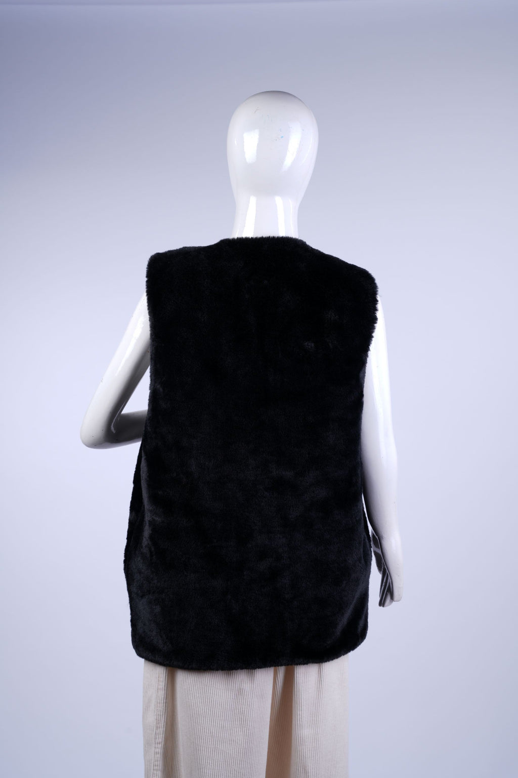Versatile plush vest perfect for layering over sweaters or tops in colder weather.