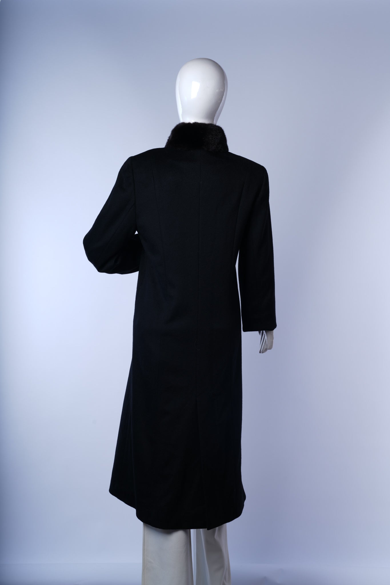 Sophisticated black women's long coat ideal for cold-weather styling.