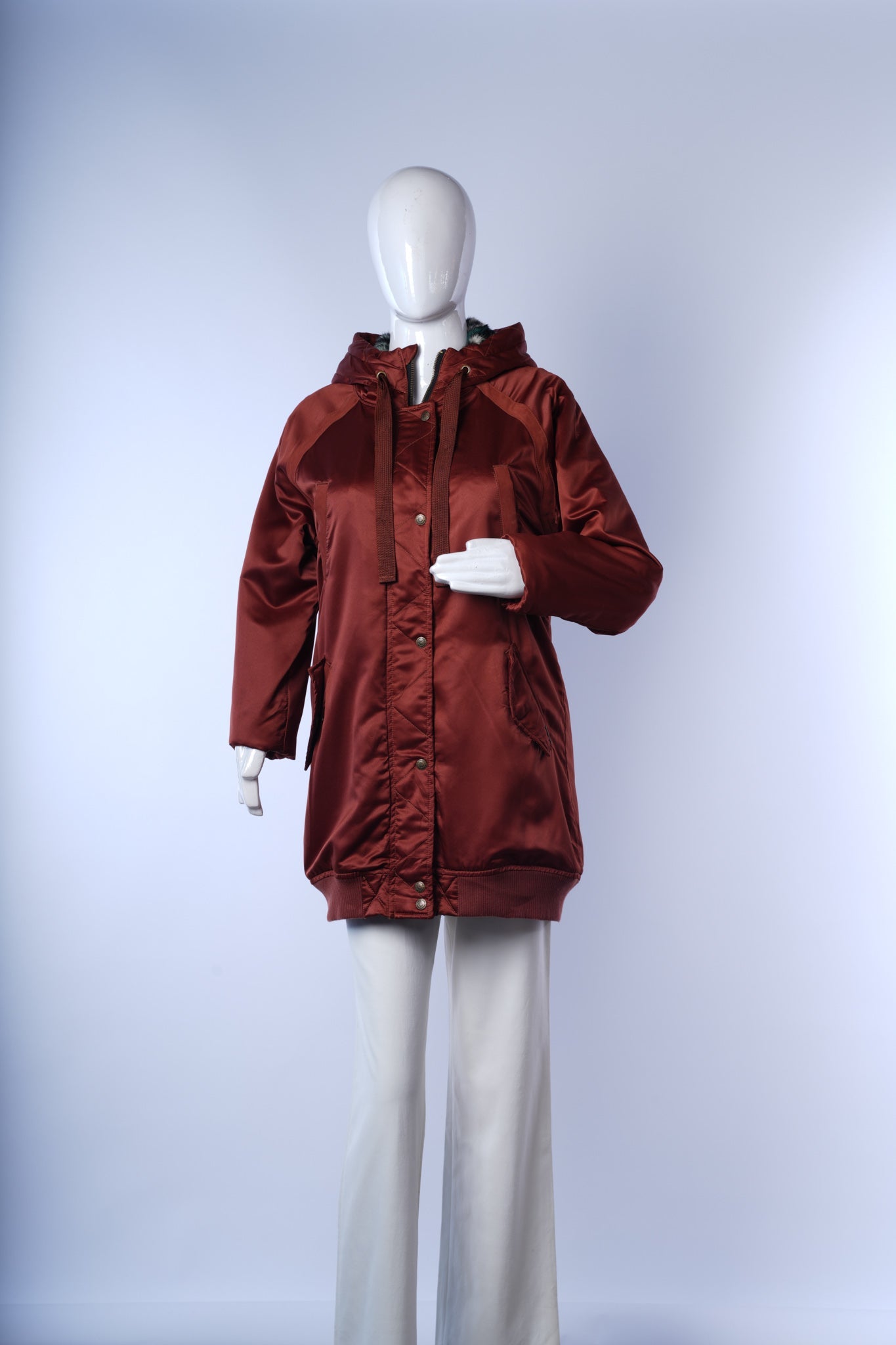 Casual rust-colored women's winter jacket with cozy quilted design and hood.