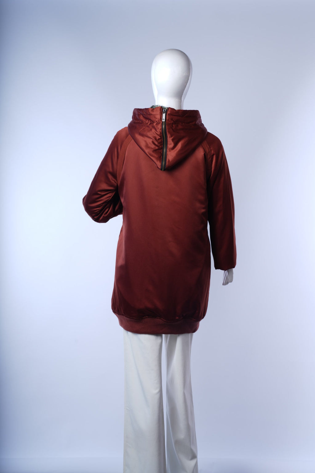 Warm rust winter jacket for women featuring full zipper closure and ribbed cuffs.