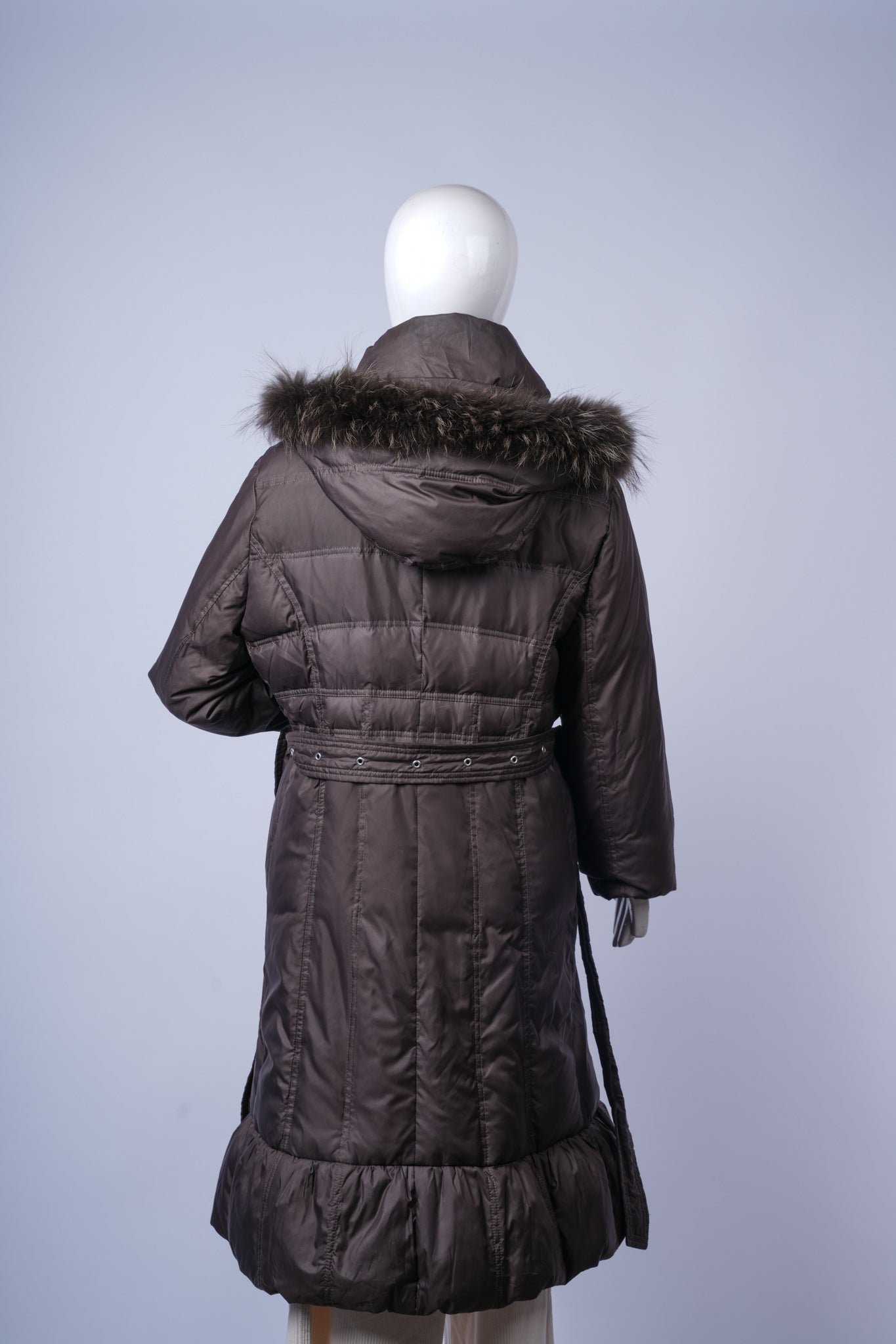 Warm quilted women's coat perfect for cold-weather layering with belt detail.