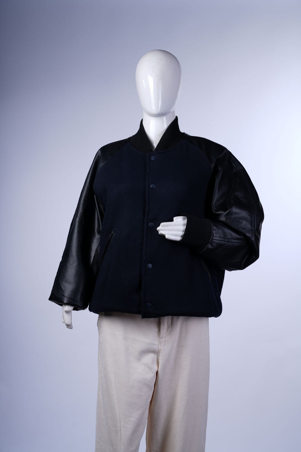 Two-tone letterman-style jacket featuring snap buttons and ribbed trims.