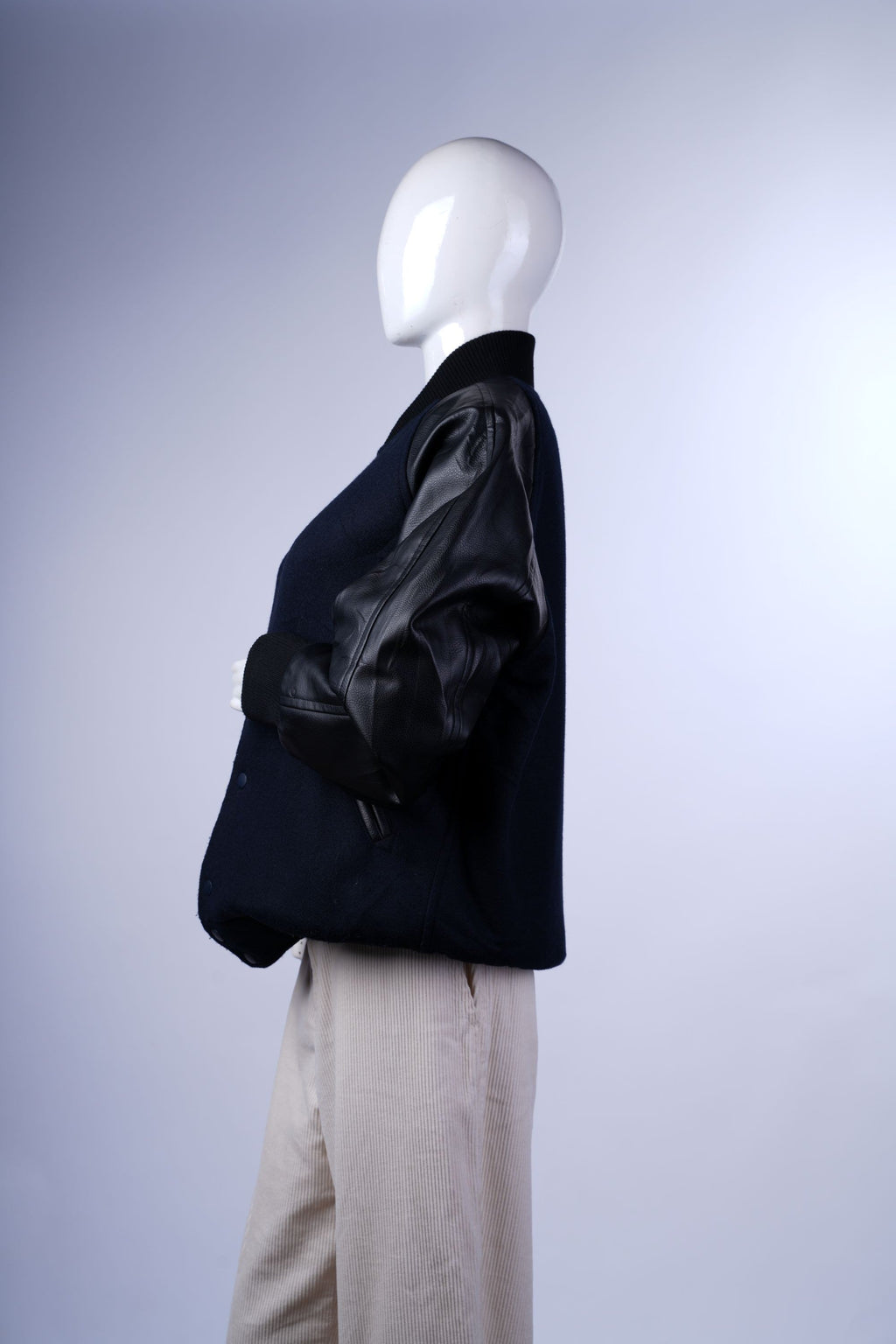 Vintage-inspired varsity coat with contrasting textures and functional side pockets.