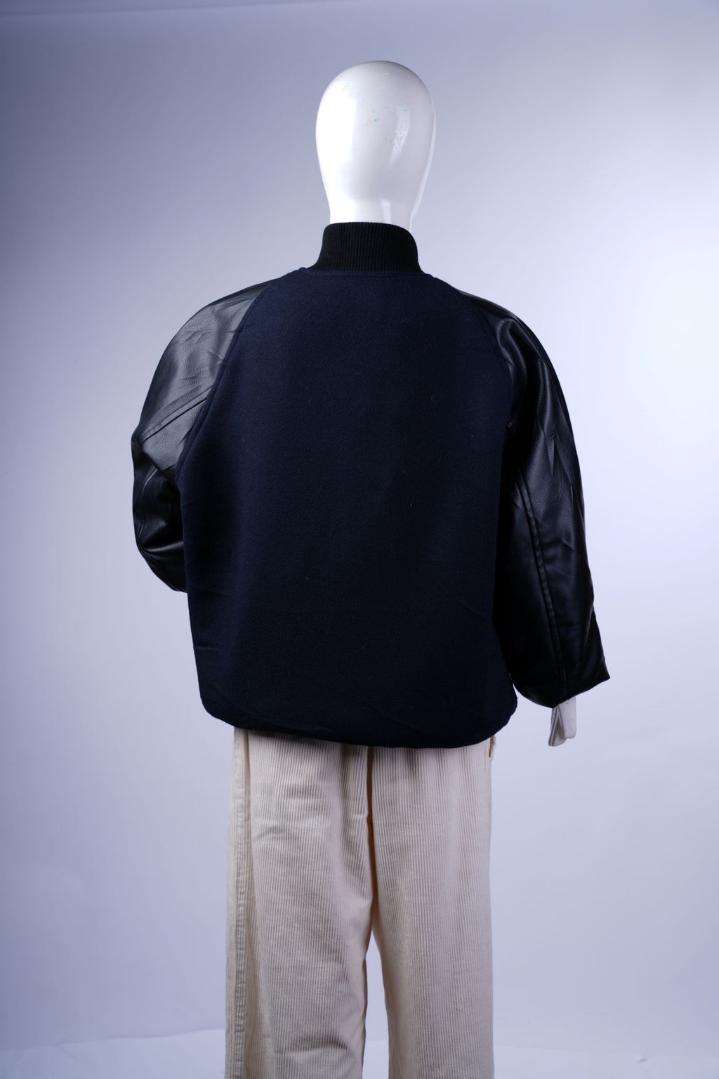 Wool and faux leather varsity jacket offering timeless athletic-inspired style.