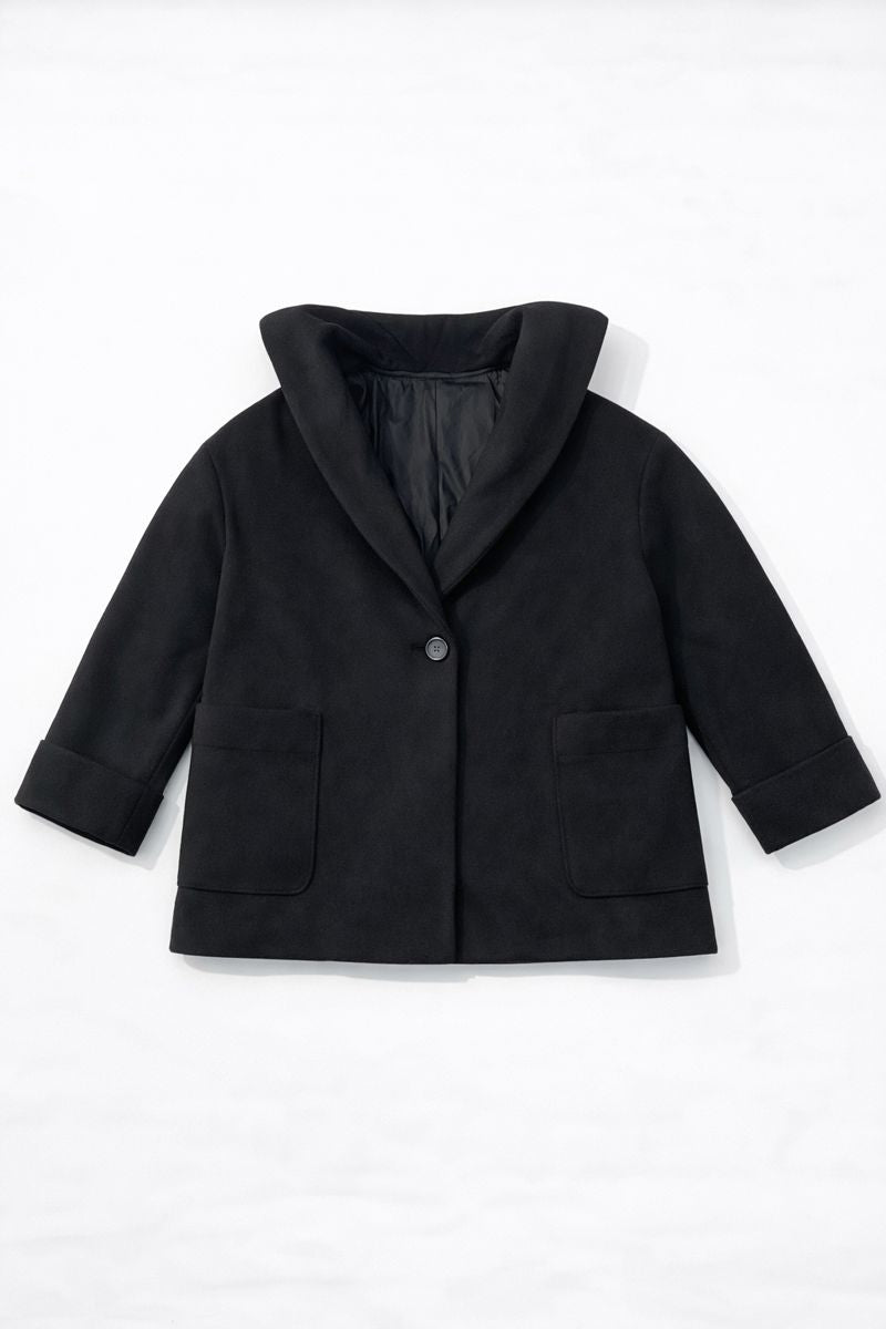 Short black coat with high stand-up collar, three-quarter sleeves, and single-button closure