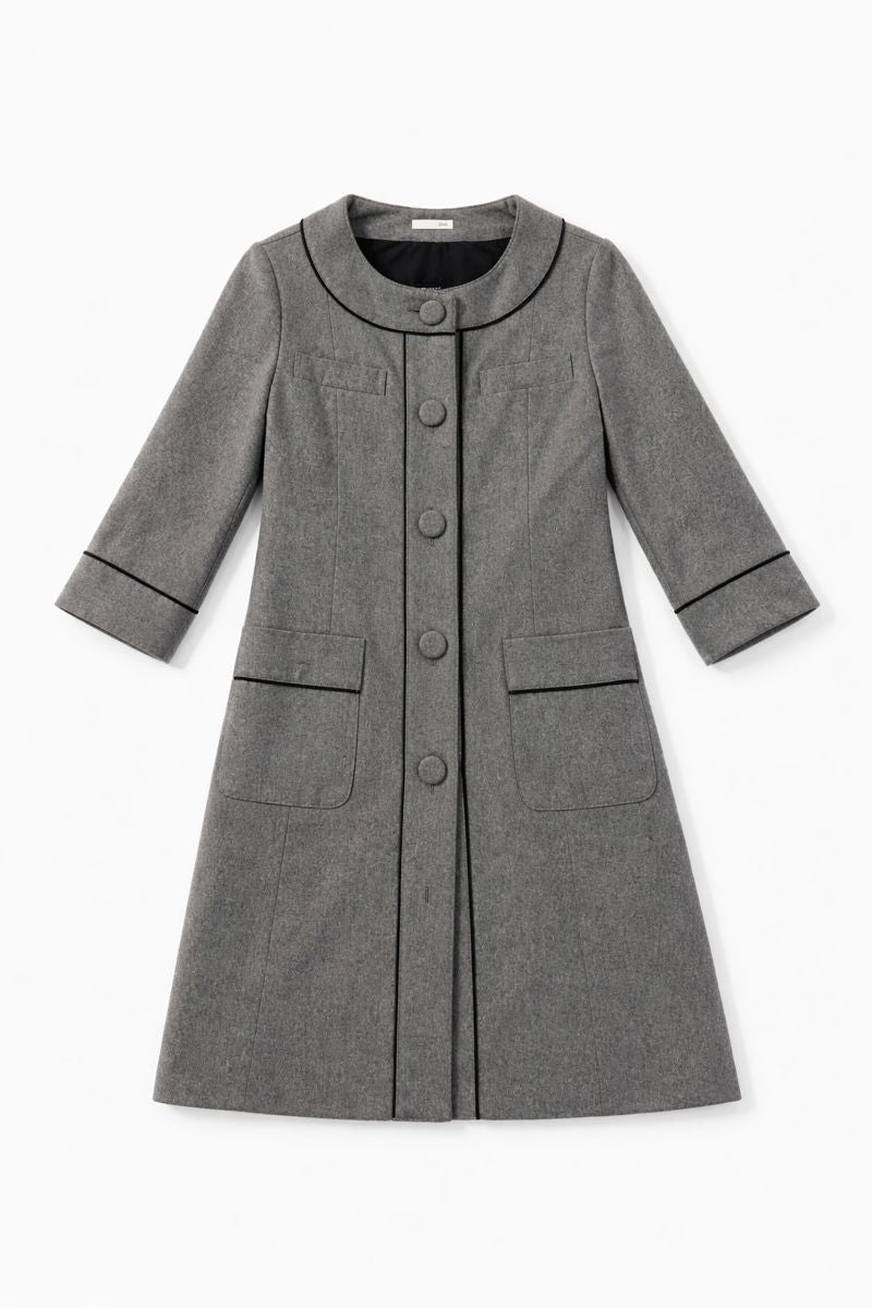 Grey collarless wool-blend coat with black piping and patch pockets