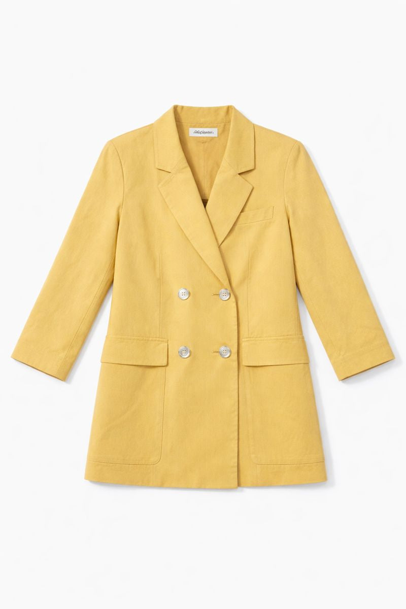 Bright yellow double-breasted blazer with pointed lapels, front flap pockets, and long sleeves