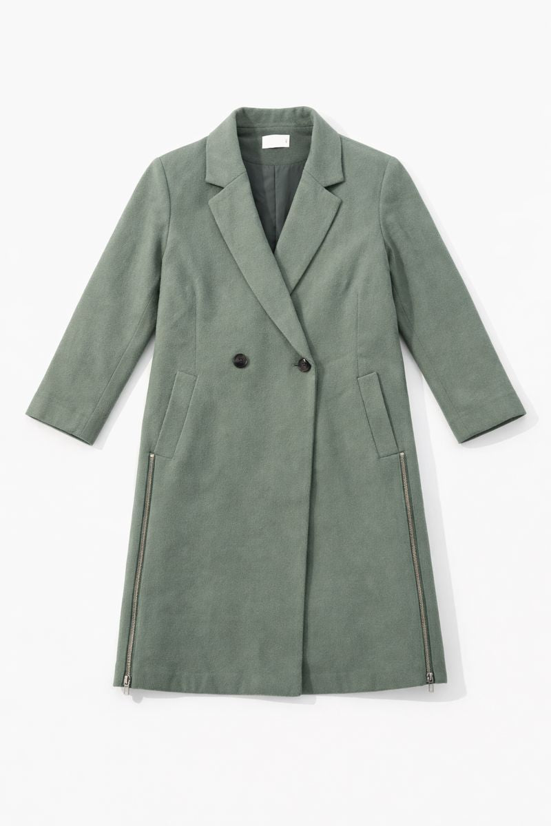 Long double-breasted coat with notched lapels, hidden front closures, and relaxed fit