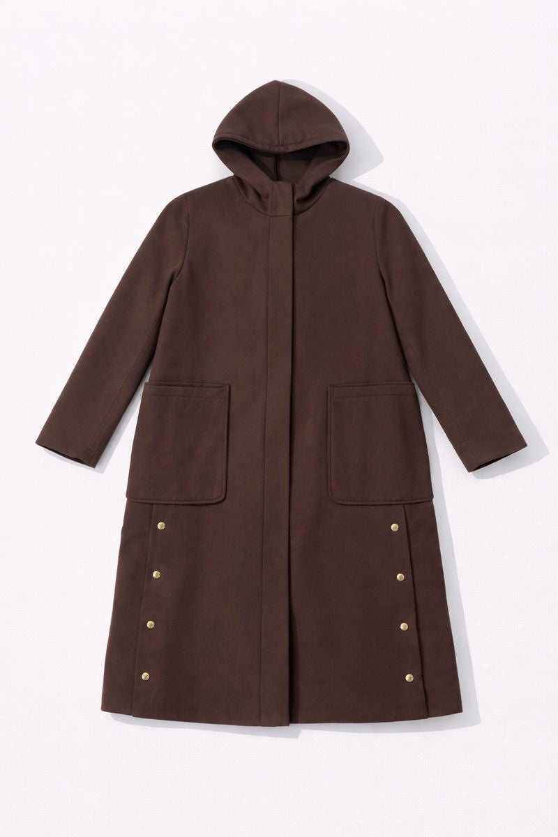 Long hooded coat with patch pockets, straight sleeves, and decorative gold buttons along lower side seams