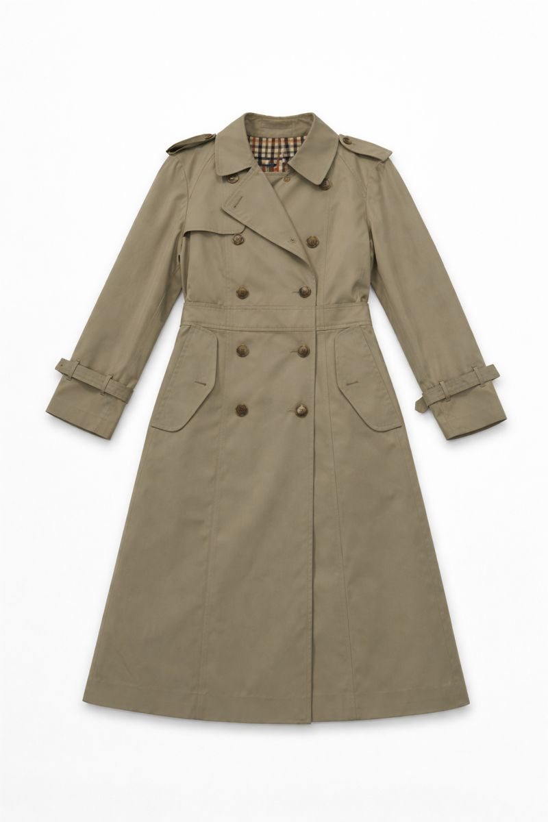 Double-breasted trench coat with belt, epaulettes, pointed collar with throat latch, belted cuffs, and side welt pockets
