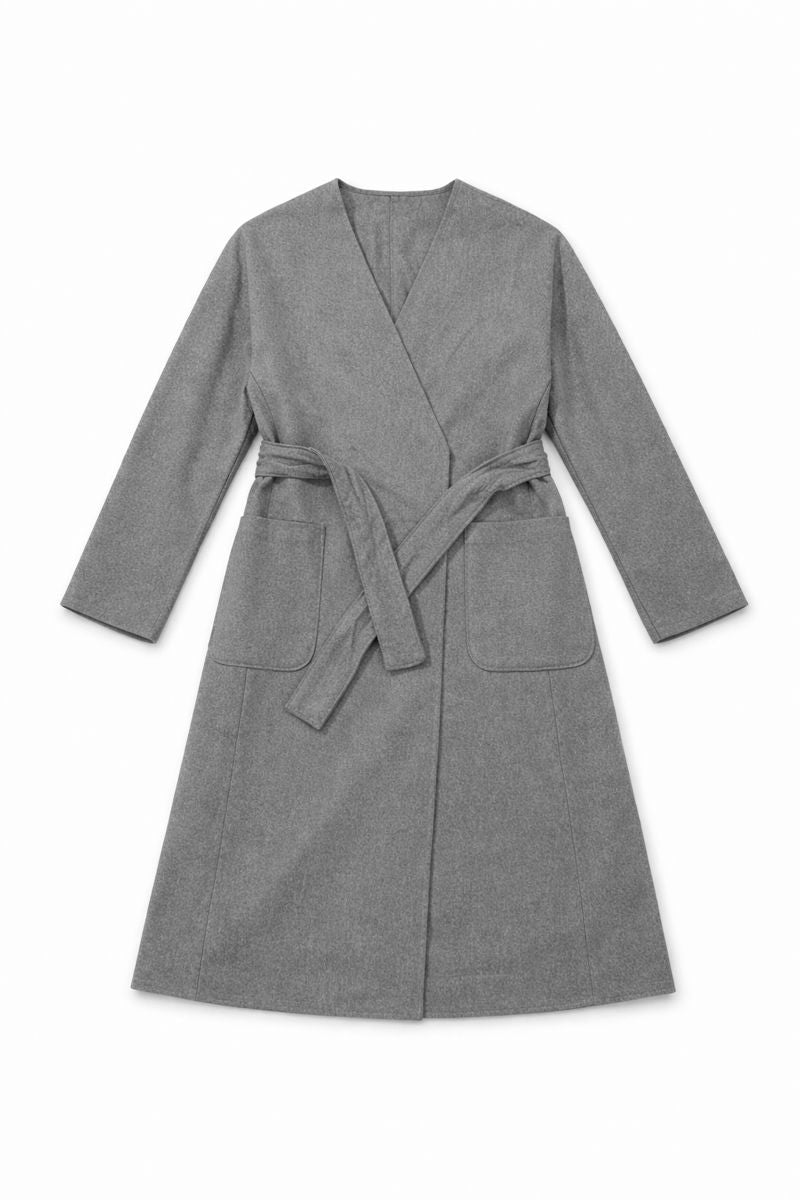 Long belted coat with classic collar, side pockets, and adjustable waist tie