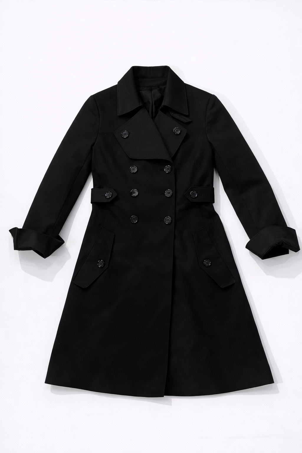 Double-breasted trench coat with wide lapels, turned-up cuffs, and belted waist