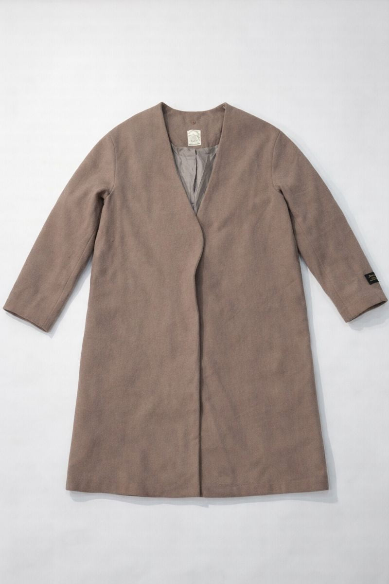 Shop a no-collar long coat with V-neck, snap-button fly front, and wool-blend fabric?erfect for modern, versatile winter styling.