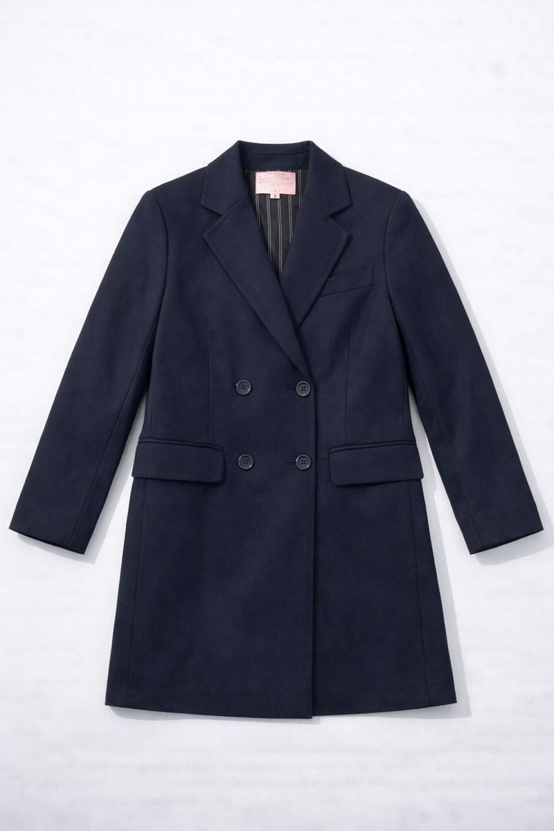 Royal blue double-breasted long coat with notched lapels, flap pockets, and full-length sleeves