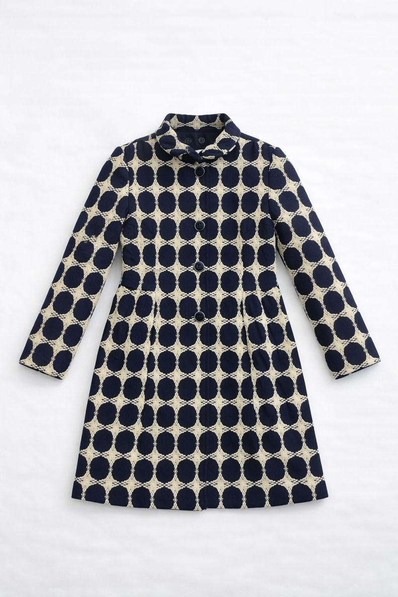 Knee-length coat with high collar and black-and-white polka dot pattern